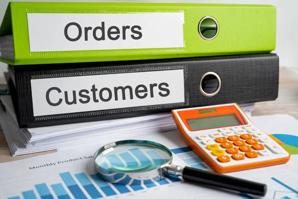 Orders, Customers. Binder data finance report business with graph analysis in office.