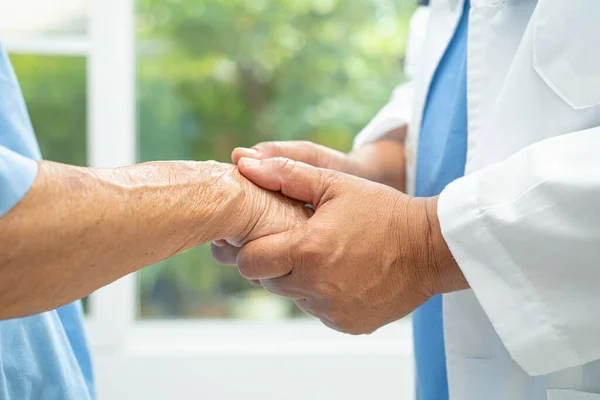 stock image Caregiver holding hands Asian elderly woman patient with love, care, encourage and empathy at nursing hospital, healthy strong medical concept.