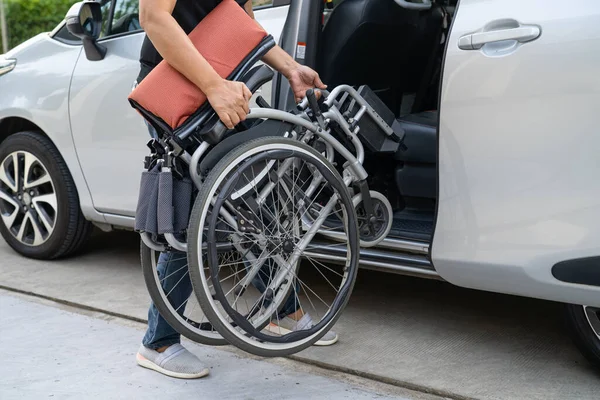 Asian disability woman on wheelchair getting in her car, Accessibility concept.