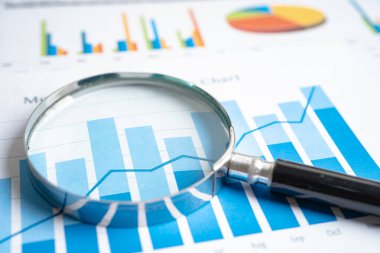 Magnifying glass on graph paper. Financial development, Banking Account, Statistics, Investment Analytic research data economy, Business concept.