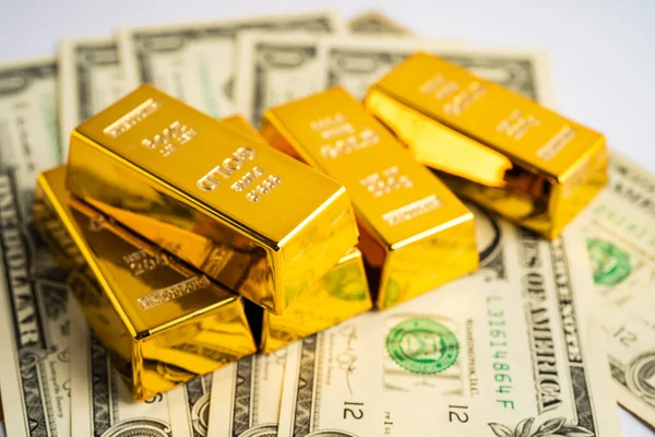 stock image Gold bar on US dollar banknotes money, economy finance exchange trade investment concept.