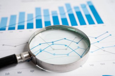Magnifying glass on graph paper. Financial development, Banking Account, Statistics, Investment Analytic research data economy, Business concept.