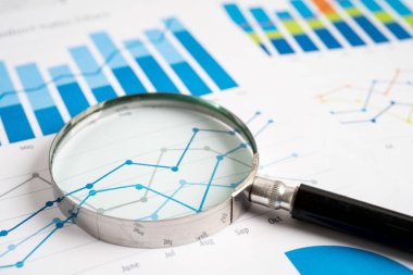 Magnifying glass on graph paper. Financial development, Banking Account, Statistics, Investment Analytic research data economy, Business concept.
