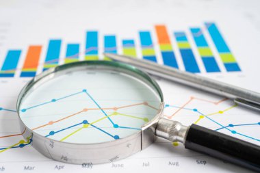 Magnifying glass on graph paper. Financial development, Banking Account, Statistics, Investment Analytic research data economy, Business concept.