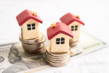 House model with stack of coin money, home loan, saving plan, installment payment finance and banking concept.