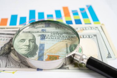 Magnifying glass on graph paper. Financial development, Banking Account, Statistics, Investment Analytic research data economy, Business concept.