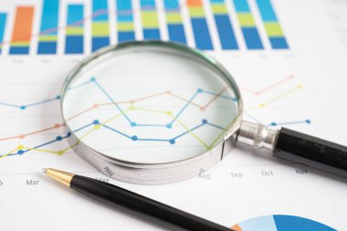 Magnifying glass on graph paper. Financial development, Banking Account, Statistics, Investment Analytic research data economy, Business concept.