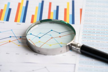Magnifying glass on graph paper. Financial development, Banking Account, Statistics, Investment Analytic research data economy, Business concept.