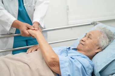 Doctor using stethoscope to checking the patient lie down on a bed in the hospital, healthy strong medical concept. clipart