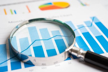 Magnifying glass on graph paper. Financial development, Banking Account, Statistics, Investment Analytic research data economy, Business concept.