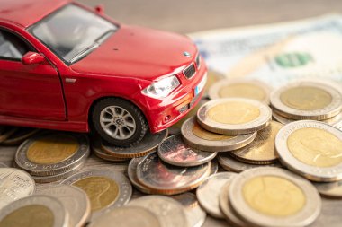 BANGKOK, THAILAND - FEBRUARY 12, 2023, Car on coins background; Car loan, Finance, saving money, insurance and leasing time concepts.