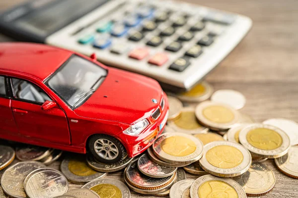 BANGKOK, THAILAND - FEBRUARY 12, 2023, Car on coins background; Car loan, Finance, saving money, insurance and leasing time concepts.
