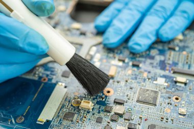 Asyalı teknisyen fırça, donanım, cep telefonu, güncelleme konsepti ile akıllı telefon elektronik teknolojisinin kirli mikro devre tamiri ve temizliği.