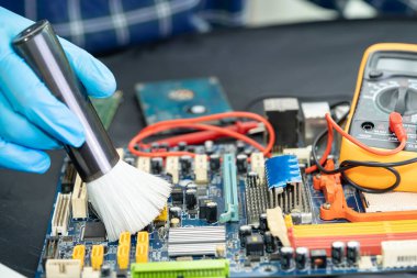 Asian technician repair and cleaning dirty micro circuit main board of smartphone electronic technology with brush, hardware, mobile phone, upgrade concept.