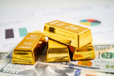 ABD doları üzerindeki altın külçeleri para ve grafik, ekonomi finans ticaret yatırım kavramı.