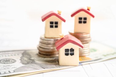 House model with stack of coin money, home loan, saving plan, installment payment finance and banking concept.