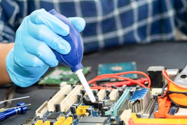 Asian technician repair and cleaning dirty micro circuit main board of smartphone electronic technology with brush, hardware, mobile phone, upgrade concept.