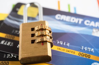 Credit card with password key lock and US dollar banknotes.