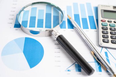 Magnifying glass on graph paper. Financial development, Banking Account, Statistics, Investment Analytic research data economy, Business concept.