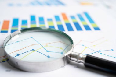 Magnifying glass on graph paper. Financial development, Banking Account, Statistics, Investment Analytic research data economy, Business concept.