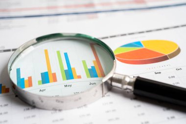 Magnifying glass on graph paper. Financial development, Banking Account, Statistics, Investment Analytic research data economy, Business concept.
