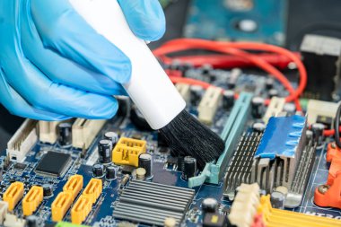 Asian technician repair and cleaning dirty micro circuit main board of smartphone electronic technology with brush, hardware, mobile phone, upgrade concept.