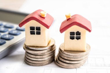 House model with stack of coin money, home loan, saving plan, installment payment finance and banking concept.