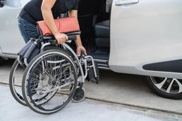 Asian disability woman on wheelchair getting in her car, Accessibility concept.