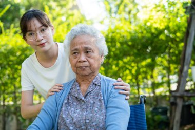 caregiver help and care Asian senior woman patient sitting on wheelchair at nursing hospital ward, healthy strong medical concept.