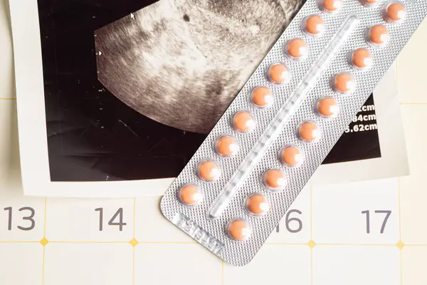 Pregnancy birth control pills with ultrasound scan of baby uterus, contraception health and medicine.