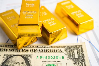 ABD doları üzerindeki altın külçeleri para ve grafik, ekonomi finans ticaret yatırım kavramı.