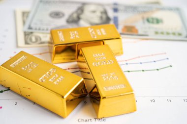 ABD doları üzerindeki altın külçeleri para ve grafik, ekonomi finans ticaret yatırım kavramı.