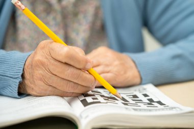 Alzheimer hastalığı AD, bunama için sudoku bulmacası oynayan Asyalı yaşlı kadın.