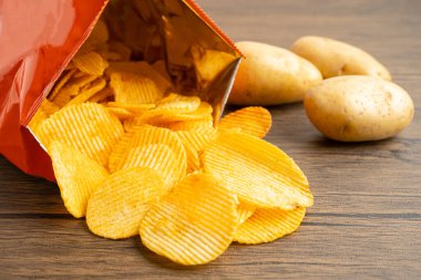 Patates cipsi, leziz BBQ baharatlı Crips için ince dilimlenmiş kızarmış abur cubur açık poşette fast food..