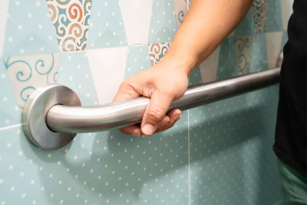 stock image Asian elderly woman use toilet bathroom handle security, healthy strong medical concept.