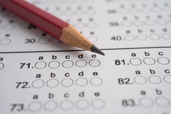 Answer sheets with pencil drawing fill to select choice, education concept.