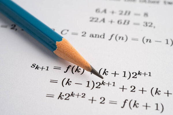 Pencil on mathematic formula exercise test paper in education school.