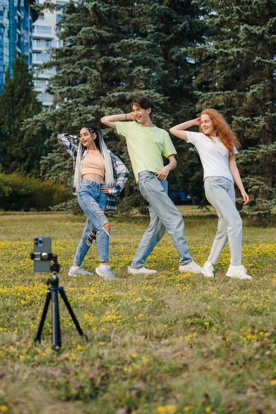 Young teenagers creating their dancing video by smartphone camera to share video on social media. Concept of social media sharing, making short videos