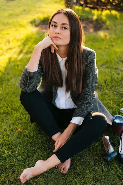 stock image Young independent woman enjoying relaxation after work in the sunset sunlight. Nature in town. Relax outdoors after work. Summer vibes.