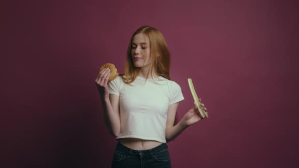 Zabawna Zamyślona Kobieta Trzymająca Warzywa Hamburgery Rękach Odizolowana Szkarłatnej Pracowni — Wideo stockowe