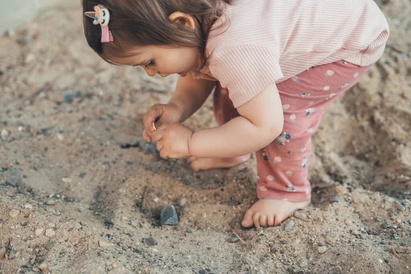 stock image Baby girl playing with sand alone at home garden. Creative play for kids concept. Concept of child development, sports and education.