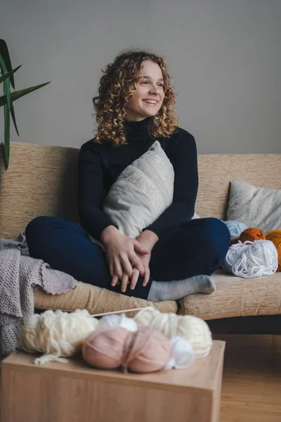 Curly Haired Smiling Woman Looking Away While Sitting Cozy Sofa — Stock Photo, Image