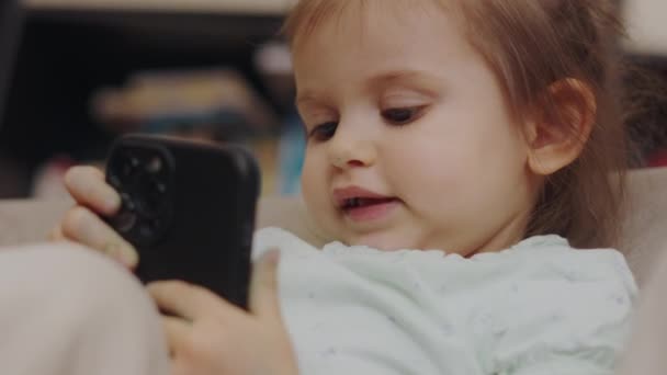 Doce Bebê Criança Sentada Poltrona Usando Telefone Móvel Tendo Concentrado — Vídeo de Stock