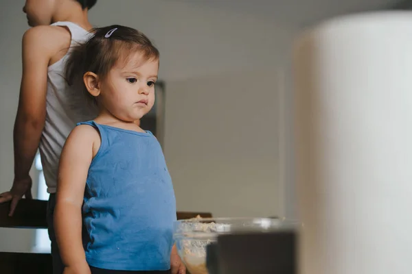 stock image Two little kids cooking bakery on the kitchen sitting on kitchen chairs. Happy family lifestyle. Food preparation.