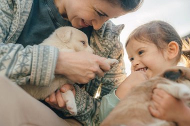 Ekin annesi, kucağında küçük bir bebekle evde hafif bir yatak odasında oturuyor.