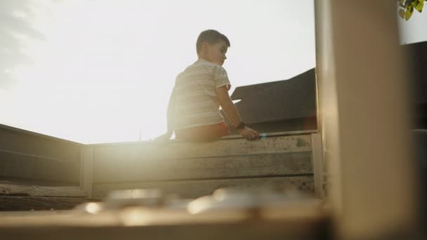Vorschulkind Spielt Hause Gegen Sonnenuntergang Hochwertiges Filmmaterial — Stockvideo