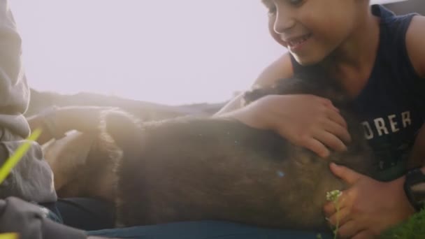 Ein Kleiner Junge Spielt Und Streichelt Seinen Kleinen Hundewelpen Grünen — Stockvideo