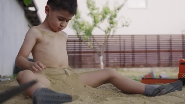 自然を楽しむ感覚の庭で砂で遊んでいる甘い幼児の少年 アウトドア活動 晴れた夏の日 リトルガーデン — ストック動画