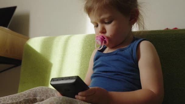 Niña Chupando Chupete Jugando Con Una Consola Juegos Portátil Videoconsola — Vídeo de stock