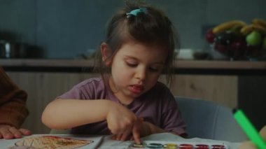 Çocuk çizimi ve boyalı elleriyle evde büyükannesiyle boyama. Birlikte oturuyoruz..